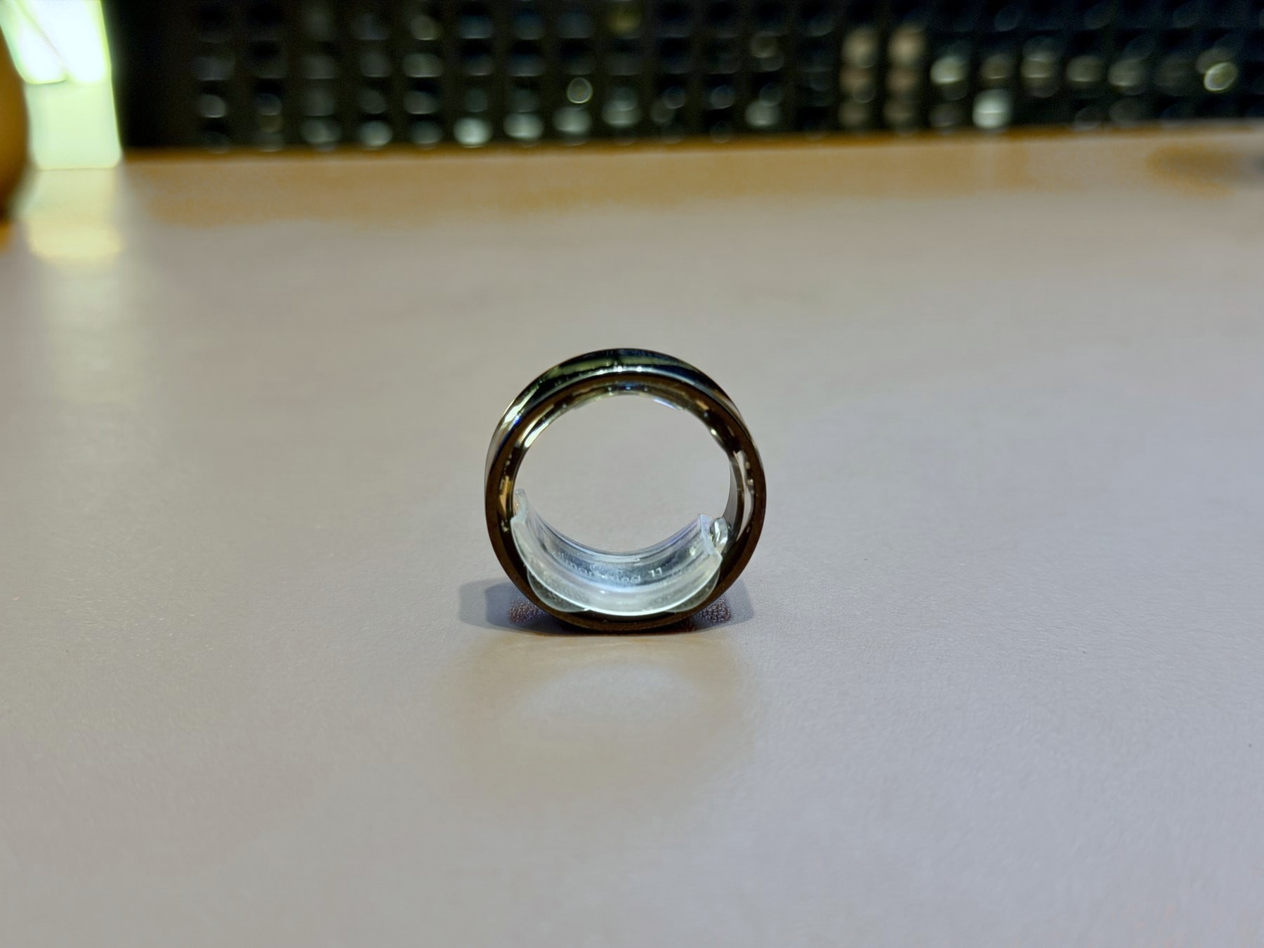 The Colmi R09 standing on my desk, with the silicone size adjuster inside the band